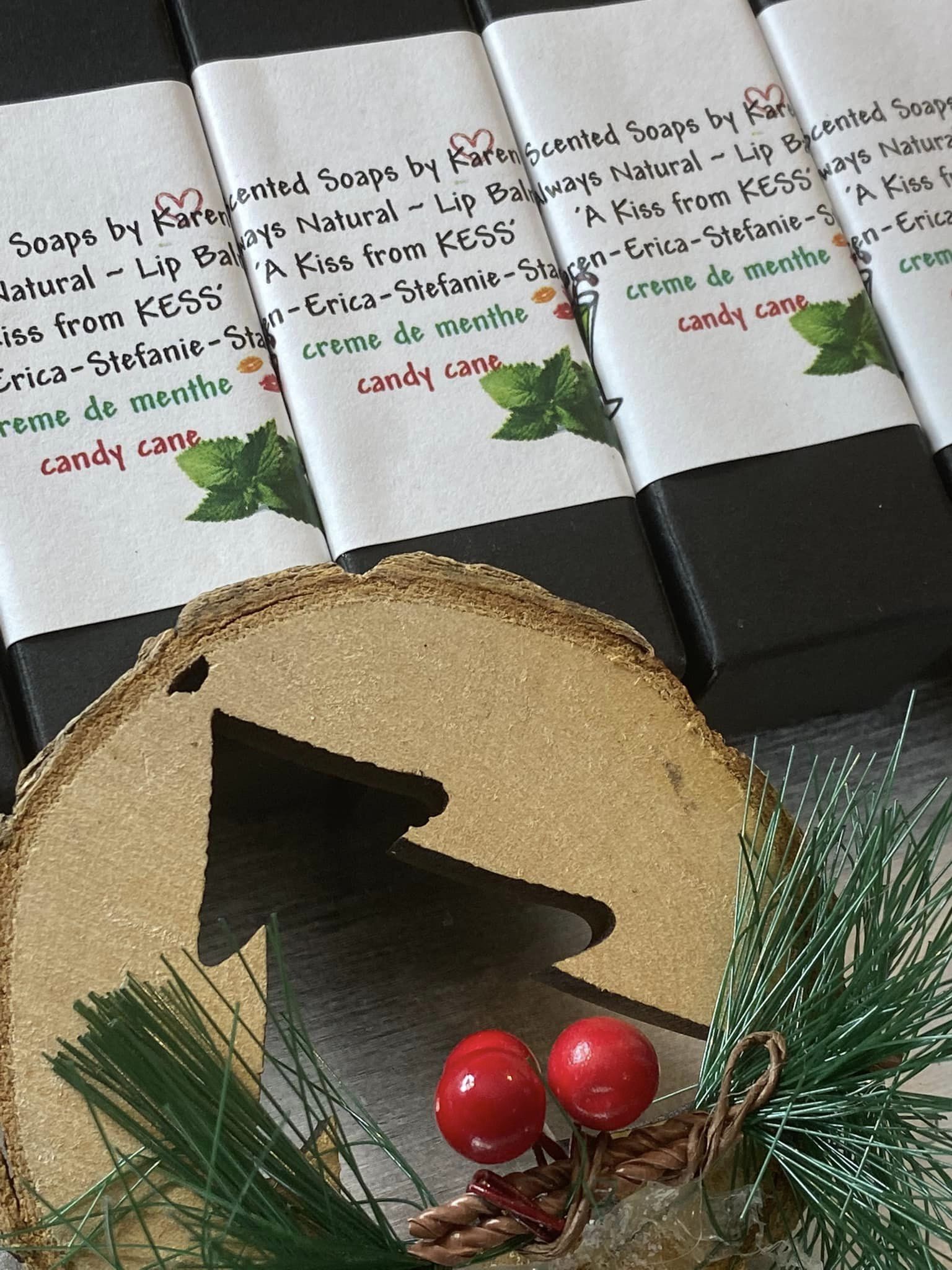 Lip Balm. 2 to a package. Candy Cane.  Black box with sticker. Made with soy, fruit oil and local beeswax