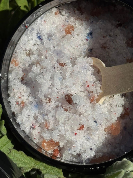 Bath Sea Salts. Lavender and Chamomile. Pink Himalayan salt. Black jars with wooden spoons.