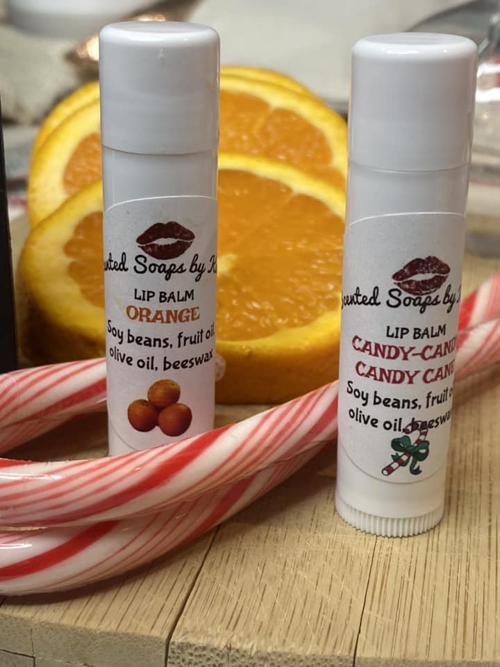 Lip Balm. 2 to a package. Candy Cane. Freshly squeezed Orange. Black box with sticker.