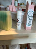 Pineapple and Tangerine Lip Balm. Pink boxes. Apple fruit, soy fruit, local beeswax.