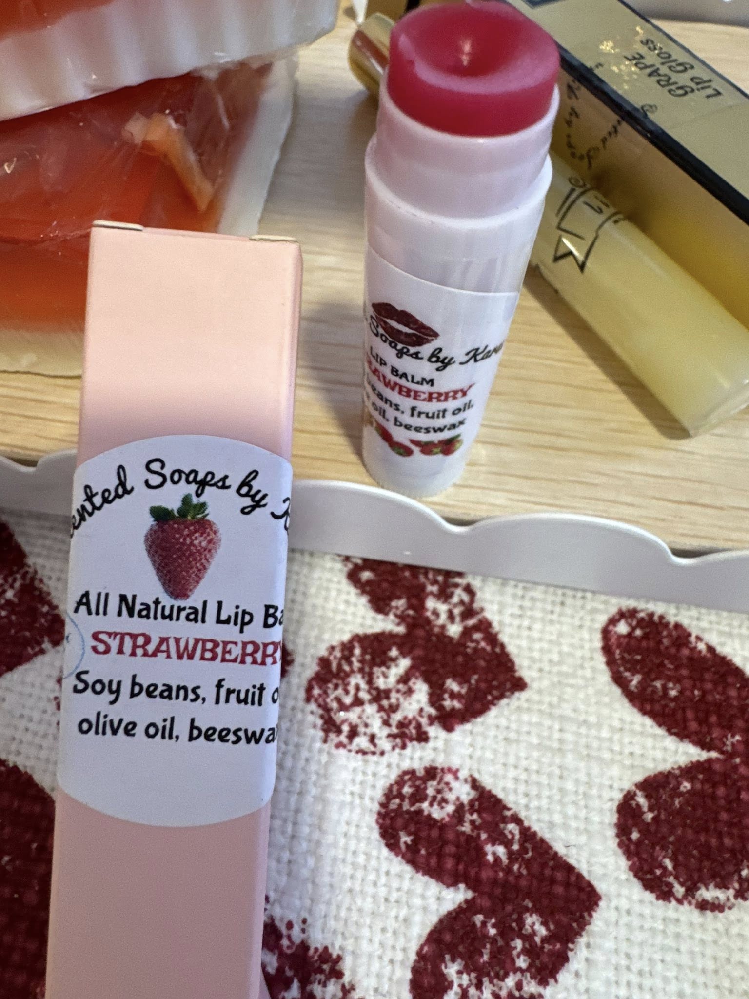Strawberry Lip Balm (tinted) Apple fruit, soy fruit, local beeswax. Packed in pink boxes.