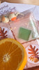 Tangerine Guest Soap Gift Set. The scent is delicious. A freshly cut orange. Four Guest Size bars. Pumpkin beads, Gold ribbon.