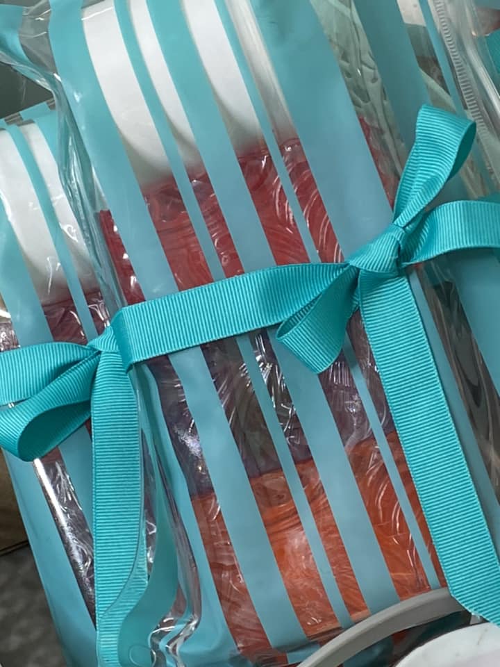 Turquoise striped clear bag with zipper.  Filled with 3 Fruity SOAPS. Glycerin. GRAPE. ORANGE. POMEGRANATE.
