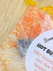 Hot Buttered Rum Shea Butter and Olive Oil Soap. Filled with orange suspension beads for easy exfoliating.