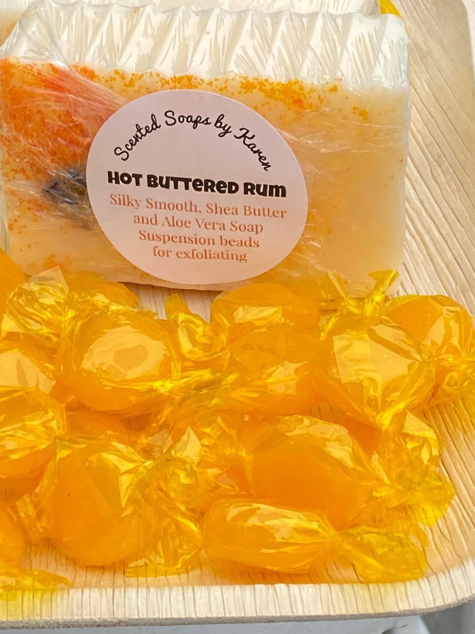 Hot Buttered Rum Shea Butter and Olive Oil Soap. Filled with orange suspension beads for easy exfoliating.